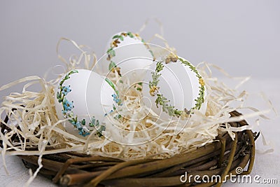 banner a lot of space for text coffee background Easter eggs decorated with painted embroidery ribbons on eggshell in Stock Photo