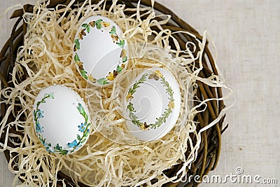 banner a lot of space for text coffee background Easter eggs decorated with painted embroidery ribbons on eggshell in Stock Photo
