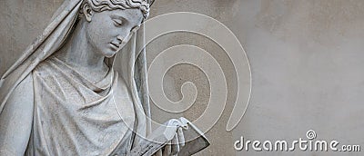 Banner with old statue of Italian or Greek Renaissance Era woman reading a book in historical downtown in Potsdam, Germany. Stock Photo