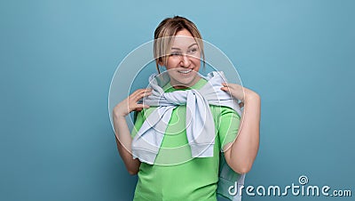 banner portrait of a positive bright girl in a casual outfit on a blue background with copy space Stock Photo