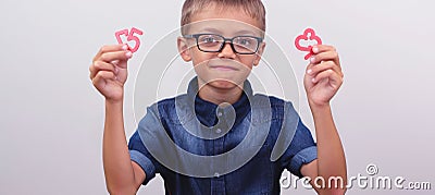 Banner Schoolboy in a blue shirt sitting at the table. Boy with glasses on white background Concept back to school Stock Photo