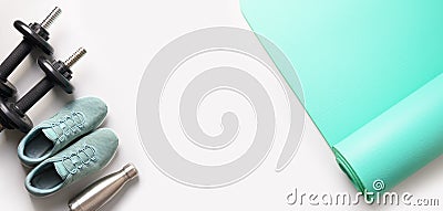 Banner of sport and fitness equipment, dumbbells, yoga mat, shoes, water bottle on grey. Top view, space for your text Stock Photo