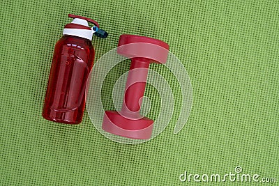 Banner of sport and fitness equipment, water bottle on green yoga mat Stock Photo