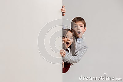 Banner with a surprised children peeking at the edge Stock Photo