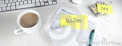 Banner with Tax time - Notification of need to file tax returns, tax form at accountant`s workplace. Top view of notepad, sticker Stock Photo