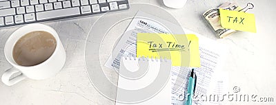 banner with Tax time - Notification of need to file tax returns, tax form at accountant's workplace. Top view of notepad Editorial Stock Photo