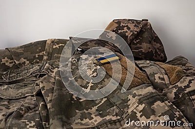 A banner of the Ukrainian flag on a soldier's pixel camouflage uniform. Ukrainian soldier uniform Stock Photo