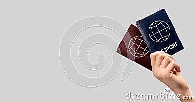 Banner with woman hand holding two passports. Multiple, dual nationality, change of citizenship, residency status. Copy Stock Photo