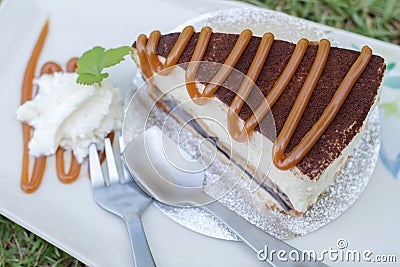 Banoffee cake pour caramel in white dish. Stock Photo