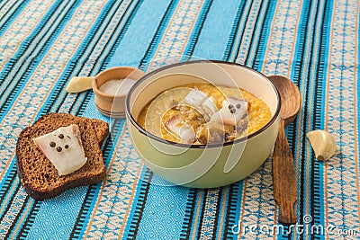 Banosh with toasted bacon, onions, rye bread with pepper and bacon Stock Photo