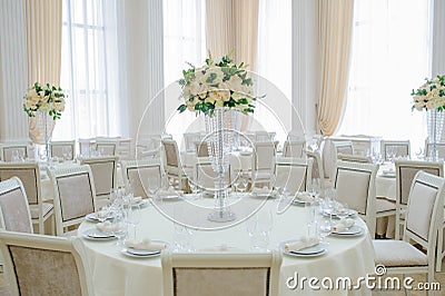 The banquet hall with round tables, with cutlery Stock Photo