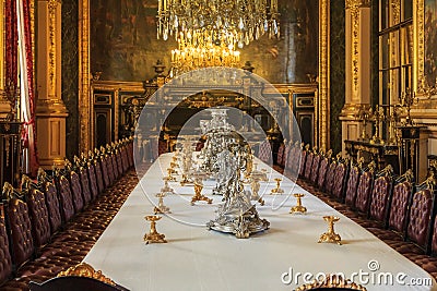 Banquet table in the apartments of Napoleon III in Louvre Museum in Paris, France with luxury baroque furnishings and stunning Editorial Stock Photo