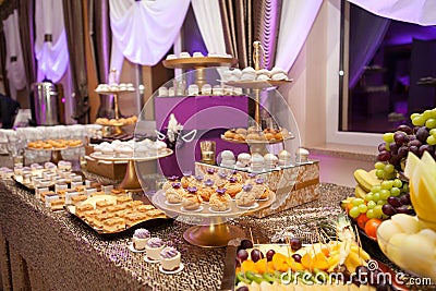 Banquet table with different food snacks, appetizers and dessetrs on corporate christmas birthday party event or wedding Stock Photo