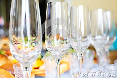 Banquet table served with instruments and decorated with empty wine glasses Stock Photo