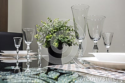 Banquet table served with instruments and decorated with empty wine glasses Stock Photo