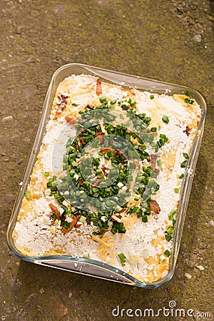 banush Hutsul cuisine. Corn porridge with cream, sheep cheese, cracklings and green onions Stock Photo