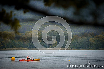 BANYOLES, SPAIN - AUGUST 7 2021: Man canoeing on the Spanish lake Banyoles Editorial Stock Photo
