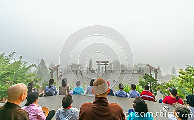 Tourists meditating in front temple as a way to relax soul Editorial Stock Photo