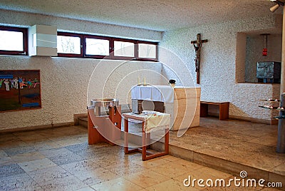A baptismal font stands in front of an Altar Editorial Stock Photo