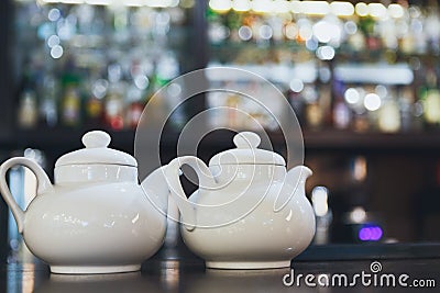 Bar counter with two white teapots Stock Photo