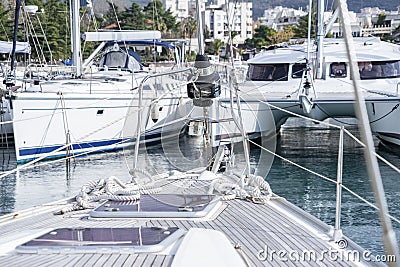 View from the deck of the yacht to its bow and folded sail Editorial Stock Photo