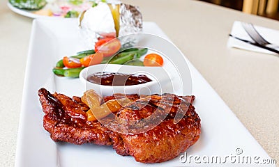 barbecue chichen on white plate in restaurant Stock Photo