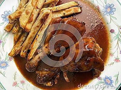 Barbecue Chicken Drumsticks With Baked Fries Stock Photo