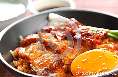 Barbecue and crispy pork with gravy sauce on rice Stock Photo