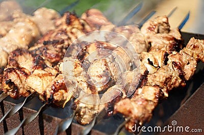 Barbecue meat on skewers. kebab on open grill Stock Photo