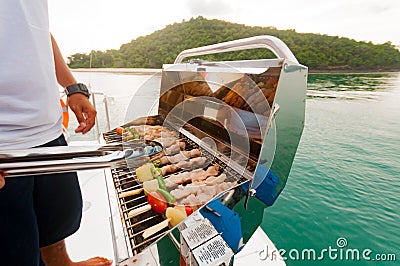 Barbecue preparing for a party on the luxury catamaran yacht Stock Photo