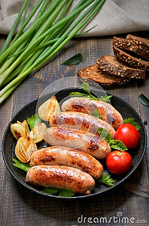 Barbecue sausages in frying pan Stock Photo