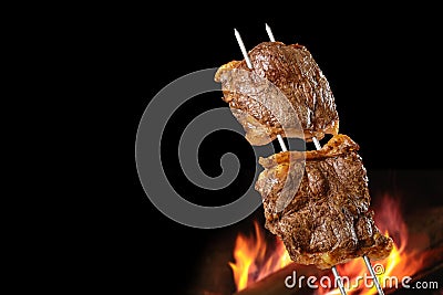 Barbecued Picanha barbecue with blurred fire in the background. Also called churrasco Stock Photo