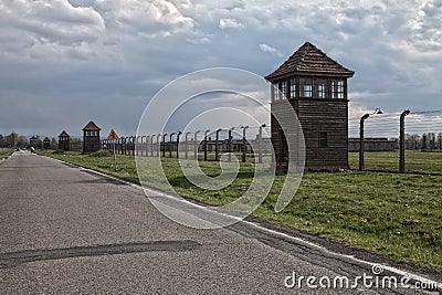 Barbed wire around a concentration camp. Shed guard in the background. Editorial Stock Photo