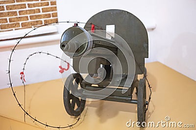 Barbed wire around the old Soviet green machine gun, machine gun on a pedestal in the Museum Editorial Stock Photo