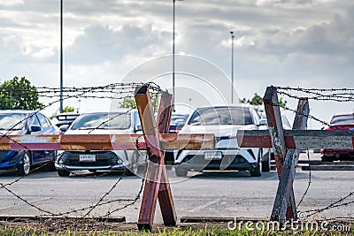 Barbed wire fence of the parking lot. Cars parked at outdoor car parking lot. Car was seized by a lending company. Financial Stock Photo