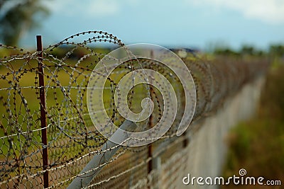Barbed wire fenced territory airport Stock Photo