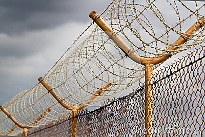 Barbed wire security perimeter fence Stock Photo