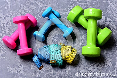 Barbells, colorful tape measures and dumbbells placed in pattern Stock Photo