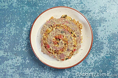 Presenting barbeque of brinjal with chopped onions, chilies, tomatoes and fried eggs with mustards oil and salt Stock Photo