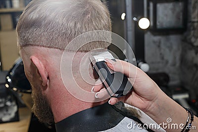 Barber hair cutting machine. The master provides a haircut Stock Photo