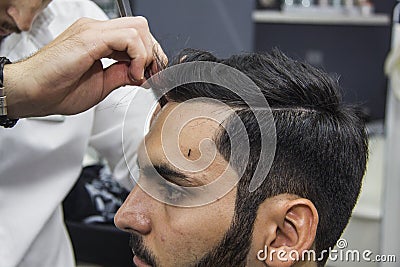 Barber cutting hair Stock Photo