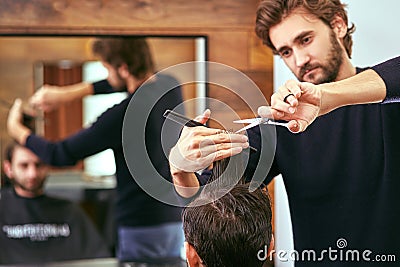 Barber makes men haircut at the beauty salon Stock Photo