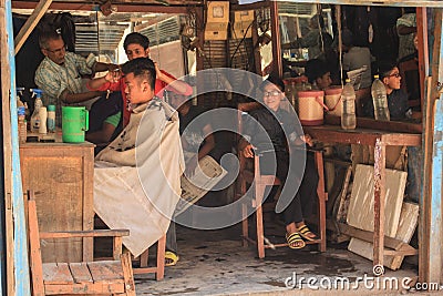 Barber for the poor in the poor quarter of Kathmandu. Street barber shop Editorial Stock Photo