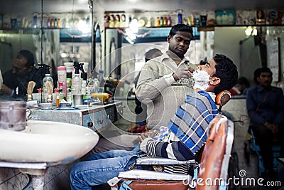 Barber shaving man in Delhi Editorial Stock Photo