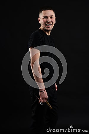 Barber Shop Concept. Smiling Handsome Young Brunete In black T Shirt Is Standing On The Pure Stock Photo