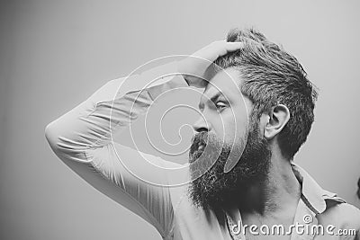 Barber shop. Hair style. Barbershop or hairdresser concept. Macho on strict face, wears unbuttoned shirt. Man with long Stock Photo