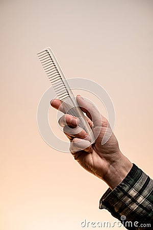 Barber shop. Barber or hairdresser male hand holding comb. Stock Photo