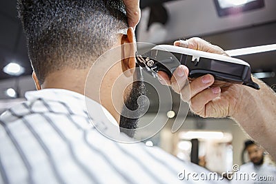 Young black man client get new haircut in barbershop Stock Photo