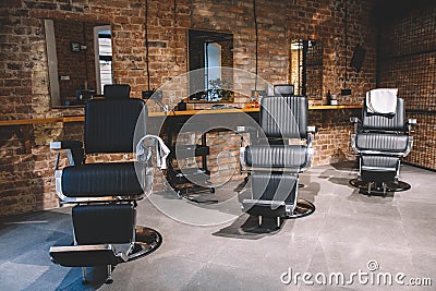 Barbershop armchair, barber shop for men. Empty chairs in retro styled barbershop. Hair salon interior. Place for text or Stock Photo