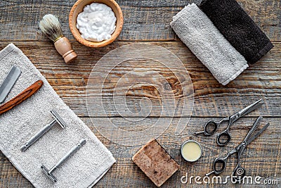 Barbershop. Men`s shaving and haircut. Brush, razor, foam, sciccors on wooden table background top view copyspace Stock Photo